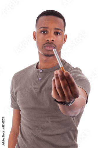 Photo: Young african american man offering a cigarette Young african american man offering a cigarette