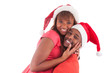Photo: Young african american couple wearing santa hat Young african american couple wearing santa hat