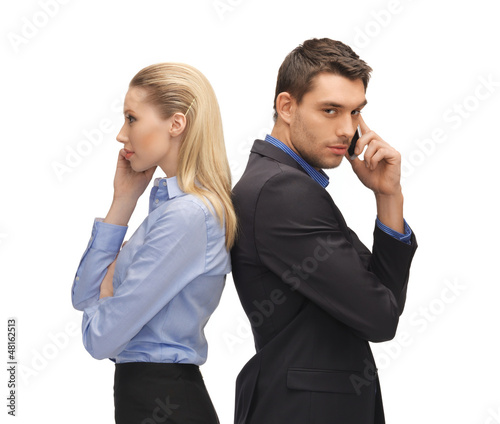 Photo: man and woman with cell phones man and woman with cell phones