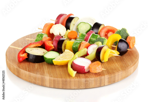 Photo: Sliced vegetables on wooden picks isolated on white Sliced vegetables on wooden picks isolated on white
