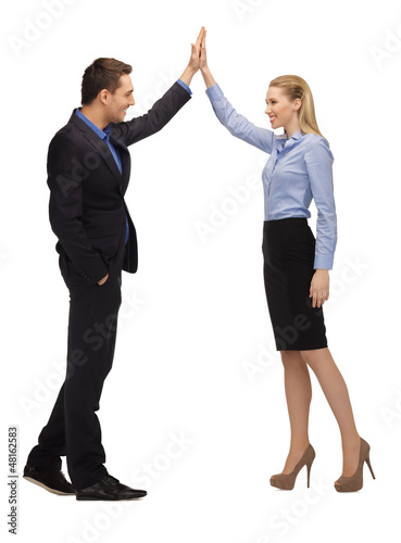 Photo: man and woman giving a high five man and woman giving a high five