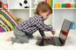 cute little boy and notebook in room