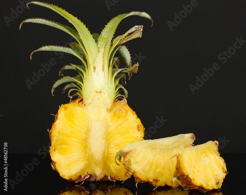 Photo: Sliced ripe pineapple isolated on black Sliced ripe pineapple isolated on black