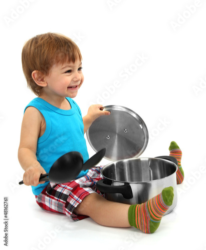 Photo: cute little boy with kitchen accessories, isolated on white cute little boy with kitchen accessories, isolated on white