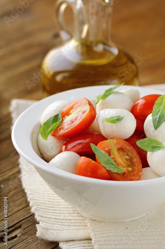 Photo: Italian Caprese salad with cherry tomatoes and baby mozzarella Italian Caprese salad with cherry tomatoes and baby mozzarella