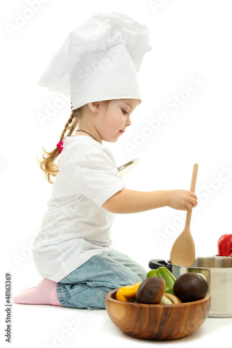 Photo: little girl in chef's hat with pan and vegetables, isolated little girl in chef's hat with pan and vegetables, isolated