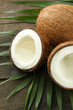 Coconut with leaves, on grey wooden background