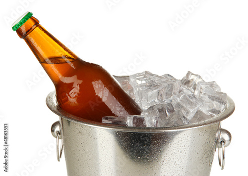 Photo: Beer bottle in ice bucket isolated on white Beer bottle in ice bucket isolated on white