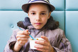 Photo: Cute teenage boy eating ice cream with chocolate topping Cute teenage boy eating ice cream with chocolate topping