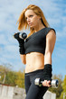 Beautiful fit woman exercising  outdoors over a sky background