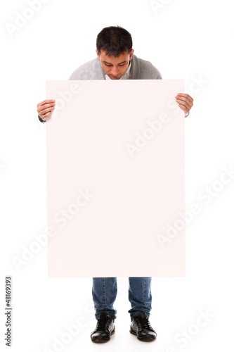 Photo: Young handsome man holding blank board Young handsome man holding blank board