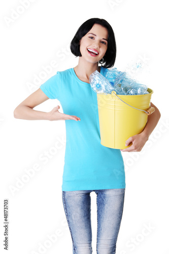 Photo: Beautiful young woman holding recycling bin Beautiful young woman holding recycling bin