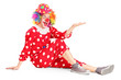 Clown with smiling joyful expression sitting down and gesturing