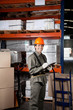 Photo: Supervisor Writing On Clipboard At Warehouse Supervisor Writing On Clipboard At Warehouse