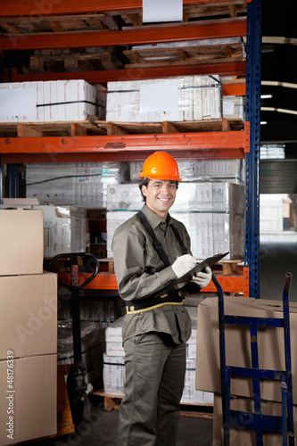 Photo: Supervisor Writing On Clipboard At Warehouse Supervisor Writing On Clipboard At Warehouse
