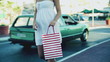 Portrait of happy young woman with shopping bags in the city, sl