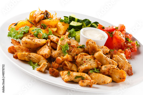 Photo: Grilled meat and vegetables on white background Grilled meat and vegetables on white background
