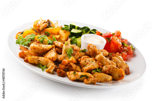Photo: Grilled meat and vegetables on white background Grilled meat and vegetables on white background