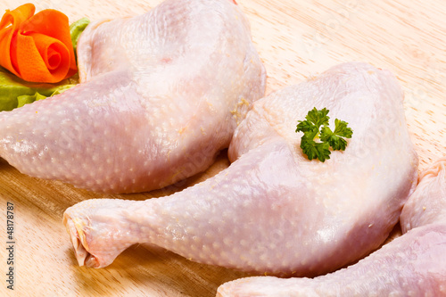 Photo: Raw chicken legs on cutting board Raw chicken legs on cutting board