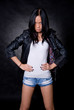 Asian girl in a studio in a leather jacket