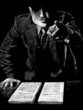 Man in a suit behind a desk in an offensive posture