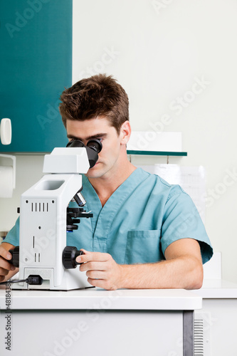 Photo: Male Researcher Using Microscope In Laboratory Male Researcher Using Microscope In Laboratory
