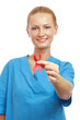 A female doctor showing a red ribbon as a symbol