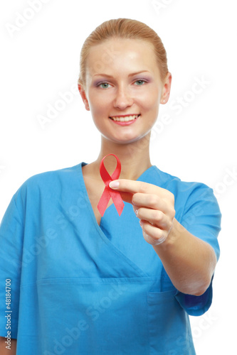 Photo: A female doctor showing a red ribbon as a symbol A female doctor showing a red ribbon as a symbol