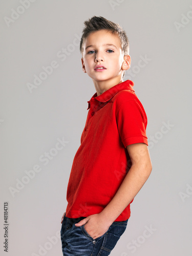 Photo: Pretty boy posing at studio as a fashion model. Pretty boy posing at studio as a fashion model.