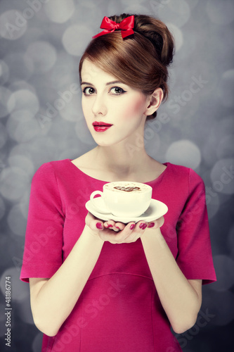 Photo: Redhead girl with coffee cup. St. Valentine's Day. Redhead girl with coffee cup. St. Valentine's Day.