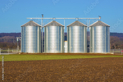 Photo: silver silo in rural landscape silver silo in rural landscape