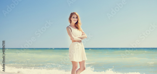 Photo: Young redhead girl at the beach. Young redhead girl at the beach.