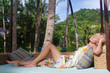Photo: young beautiful woman relaxing on natural background young beautiful woman relaxing on natural background