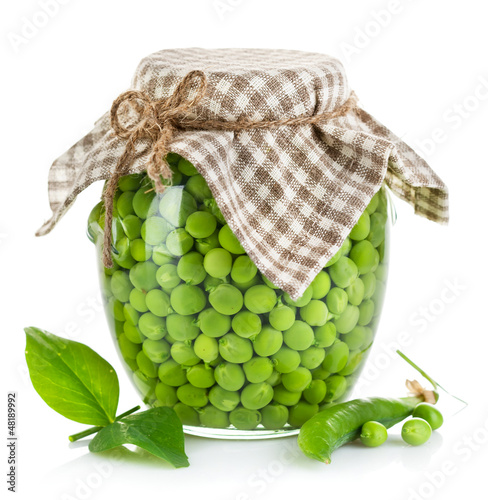 Photo: green peas in glass jar isolated on white background green peas in glass jar isolated on white background