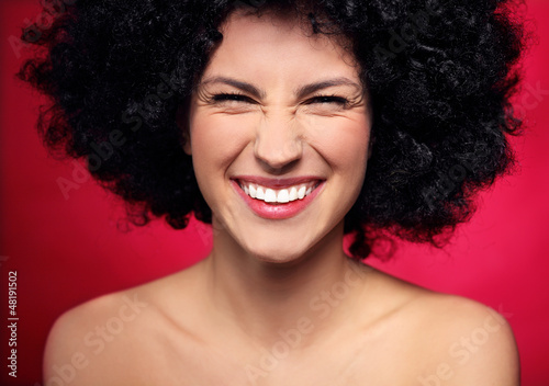 Photo: Woman with black afro hairstyle smiling Woman with black afro hairstyle smiling