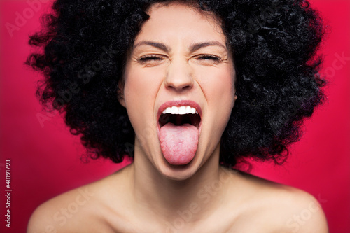 Photo: Woman sticking her tongue out Woman sticking her tongue out