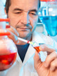 Photo: Senior scientist makes an experiment Senior scientist makes an experiment