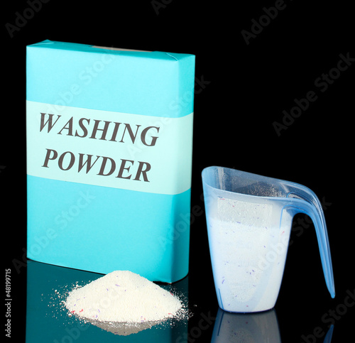 Photo: Box of washing powder with blue measuring cup, isolated on Box of washing powder with blue measuring cup, isolated on