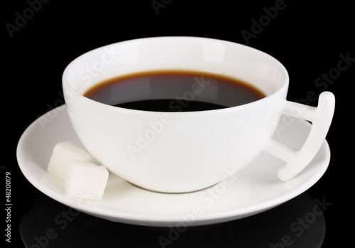 Photo: A cup of strong coffee isolated on black A cup of strong coffee isolated on black