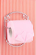 Roll of toilet paper on  holder fixed to pinstriped wall