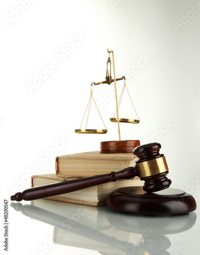 Photo: Golden scales of justice, gavel and books isolated on white Golden scales of justice, gavel and books isolated on white