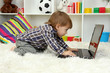 cute little boy and notebook in room