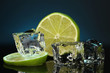 Ice cubes with lime on darck blue background