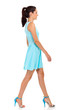 pretty young woman walking on white background