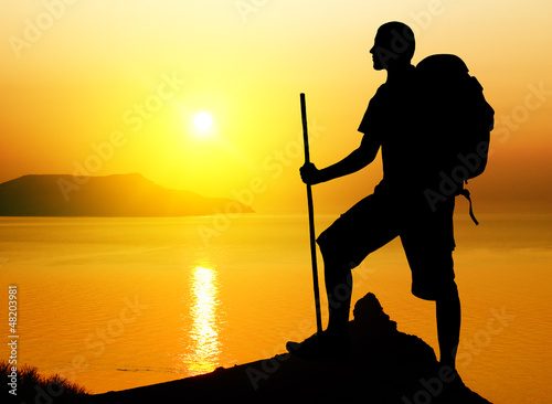 Photo: tourist on sundown background. tourist on sundown background.