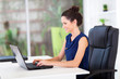 cheerful young businesswoman working in office