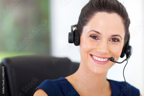 Photo: cute young business call center operator with headphones cute young business call center operator with headphones