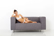 sexy young woman sitting on sofa relaxing