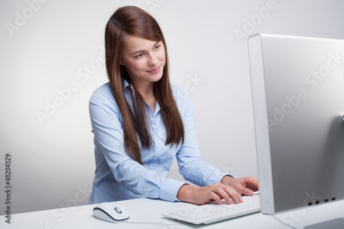 Photo: Beautiful woman working on a computer Beautiful woman working on a computer