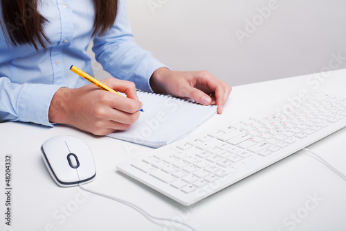 Photo: Woman writes in the notebook Woman writes in the notebook